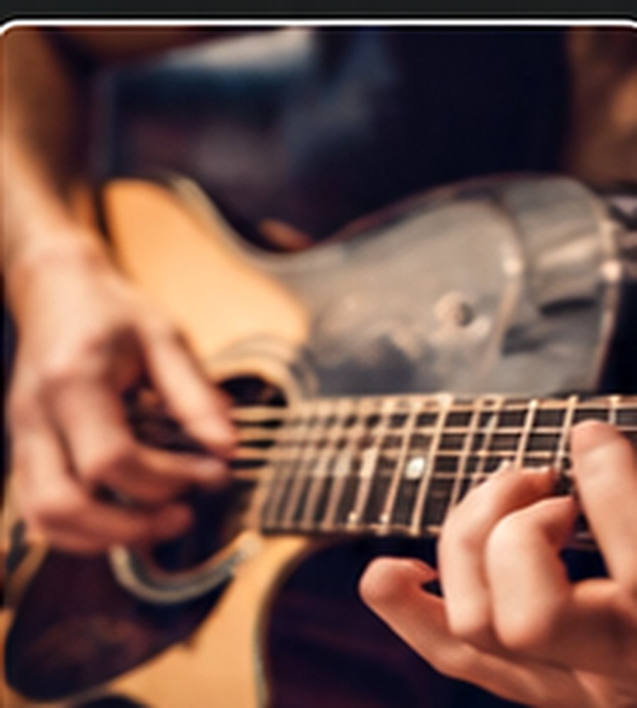 Illustrative close-up of hands playing an acoustic guitar